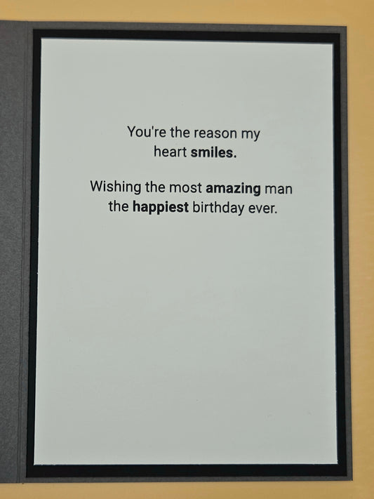 Framed card with birthday message on a plain background