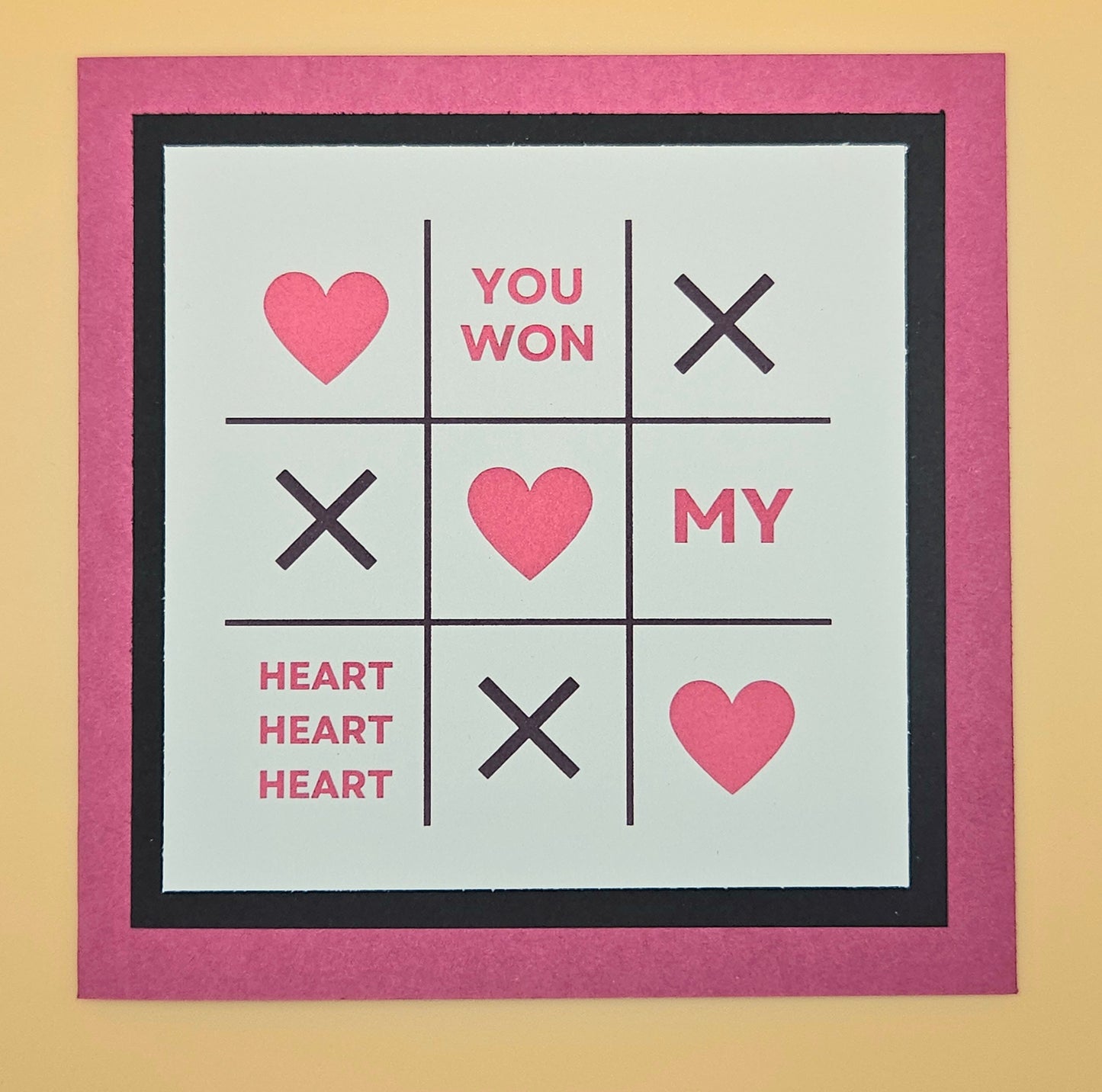 Noughts and Crosses game with hearts on a beige background