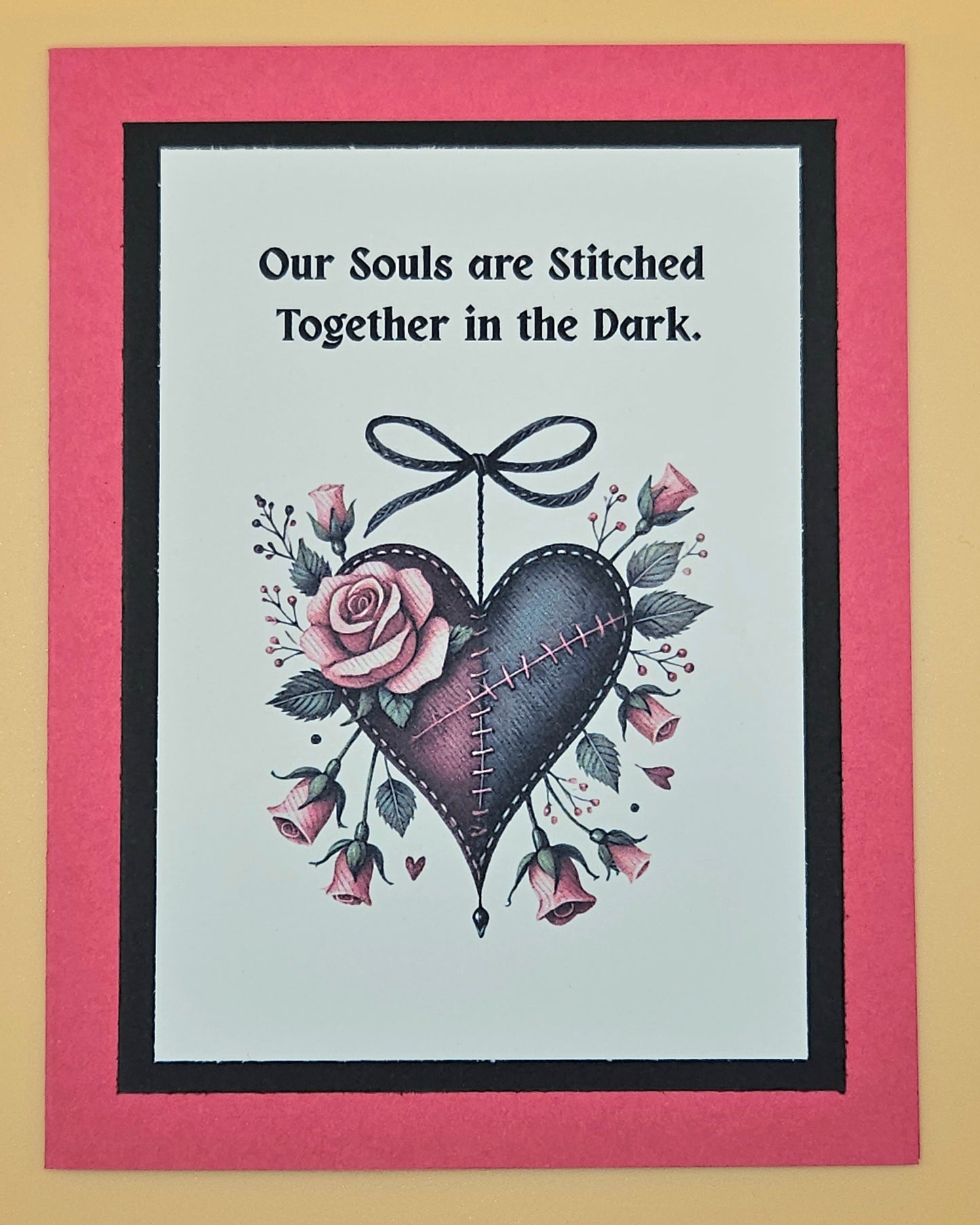 Handmade Gothic love card with stitched dark heart and rose accents on dark background. Text reads Our souls are stitched together in the dark.