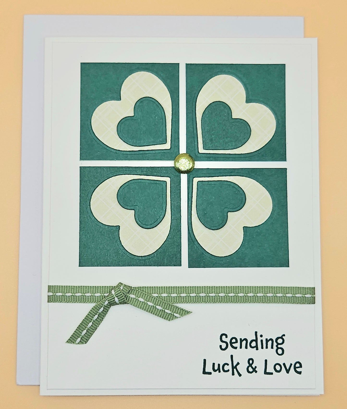 Card with heart design and text 'Sending Luck & Love' on a beige background