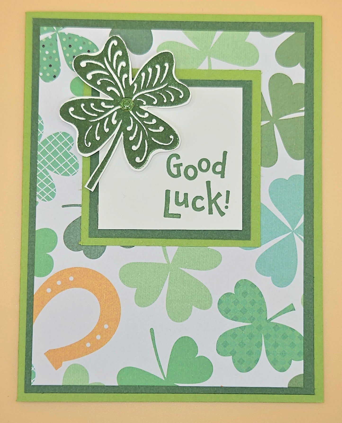 Card with shamrock design and 'Good Luck!' text on a patterned background
