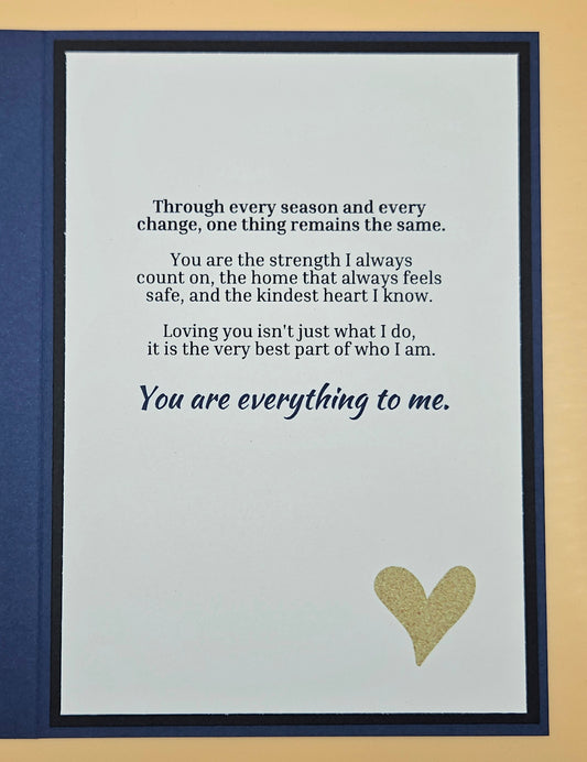 Card with a heartfelt message and a gold heart on a blue border