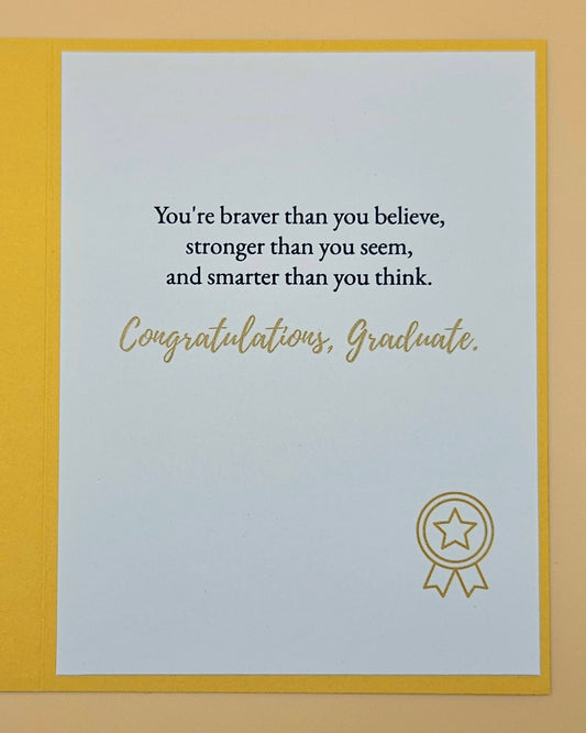 Graduation card with motivational quote and star emblem on a yellow border
