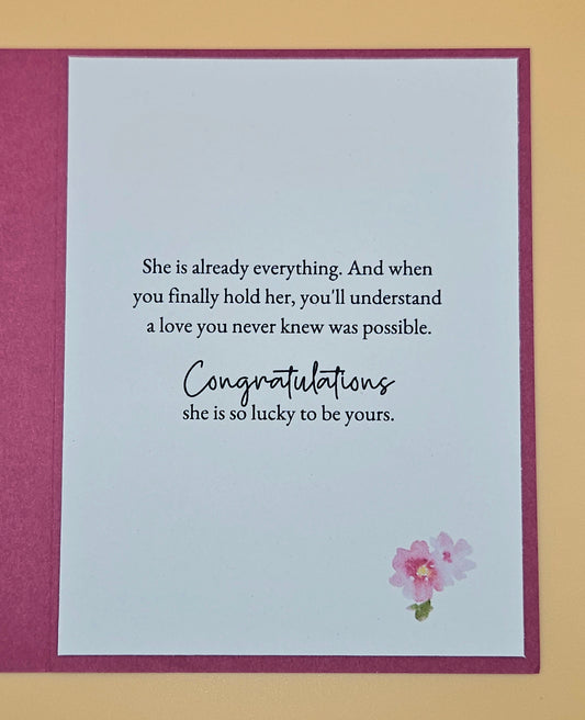 Greeting card with romantic message and pink flower on a beige background