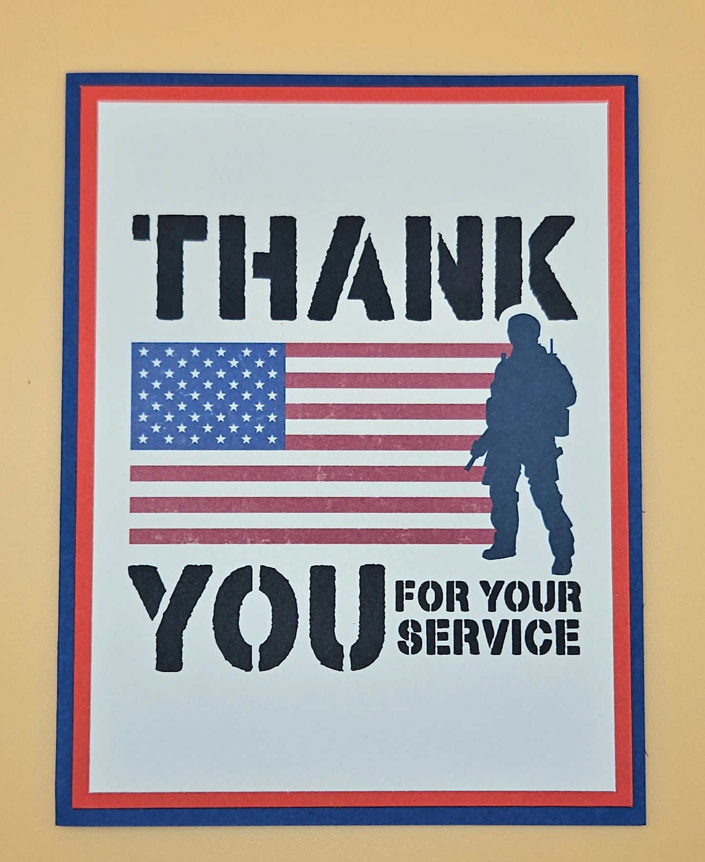 Handmade Veterans Day card with bold military stencil typography American flag and soldier silhouette on white inner panel with red and navy borders. Text reads Thank You for Your Service.