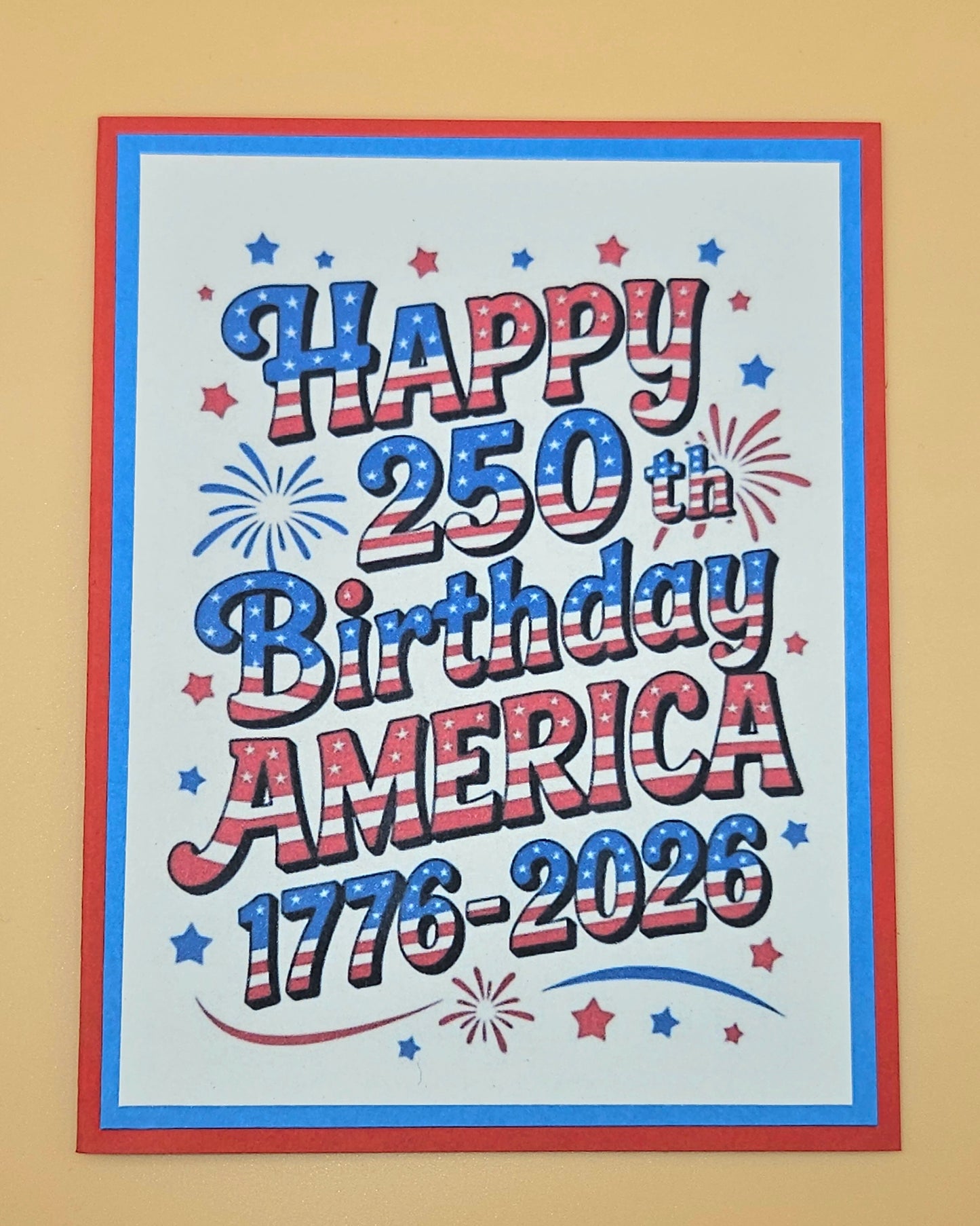 Handmade 4th of July card with bold stars and stripes typography and fireworks design on white inner panel with blue and red borders. Text reads Happy 250th Birthday America 1776-2026
