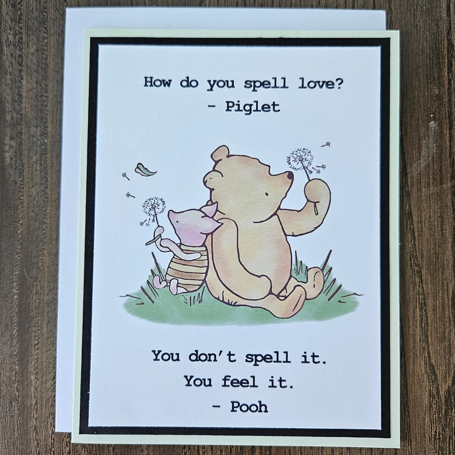 Handmade Winnie the Pooh friendship card featuring a classic hand-colored illustration of Pooh Bear and Piglet walking together, framed by layered cardstock with the quote How do you spell love.