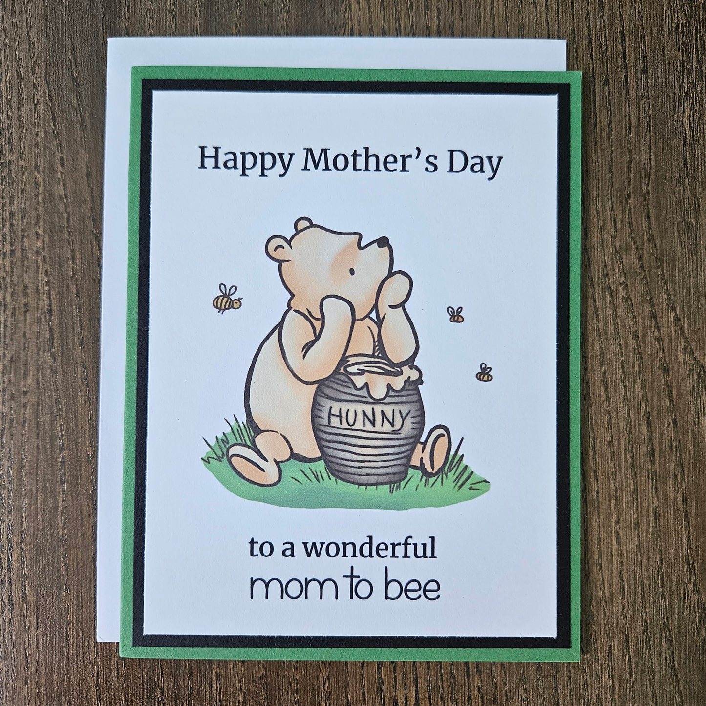 Winnie The Pooh Mother's Day card for mom to be holding a honey pot and text on a beige background
