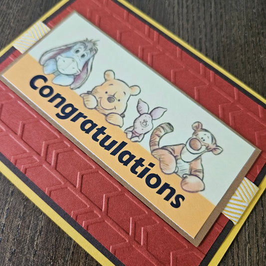 Congratulations card with cartoon characters on a textured surface
