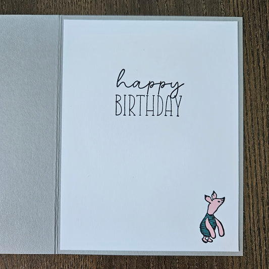 Birthday card with a fish illustration and 'Happy Birthday' text on a wooden surface