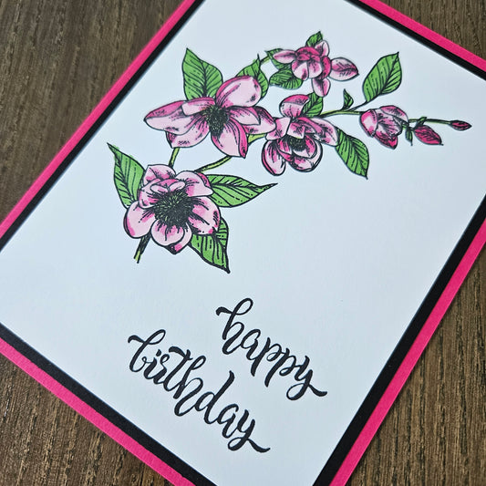 Greeting card with pink flowers and 'Happy Birthday' text on a white background