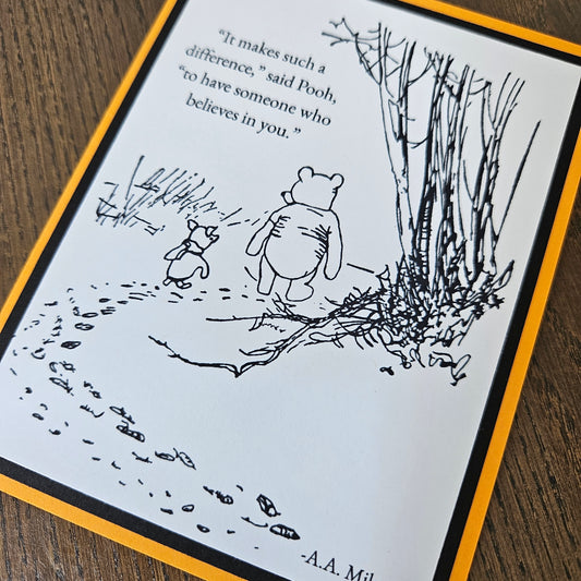 Front of a handmade A2 Winnie the Pooh friendship card featuring classic Pooh and Piglet walking together with the quote It makes such a difference to have someone who believes in you.