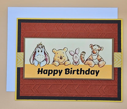 Birthday card with cartoon characters and 'Happy Birthday' text on a patterned background