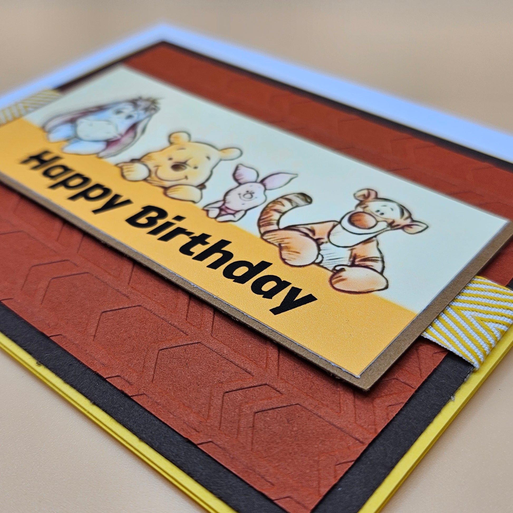 Birthday card with cartoon characters and 'Happy Birthday' text on a textured surface.