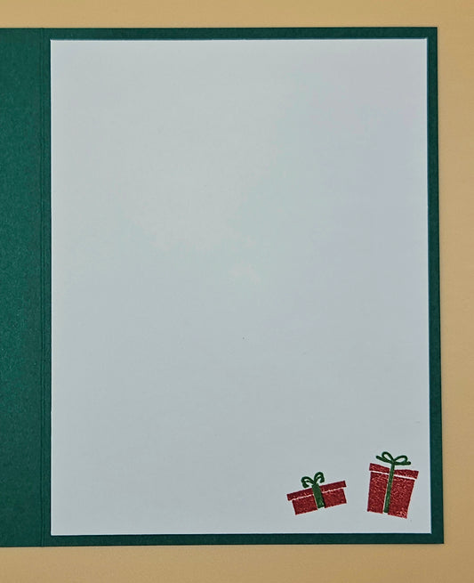 White card with red gift boxes and green ribbons on a beige background