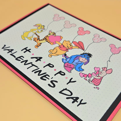Valentine's Day card with cartoon characters and 'Happy Valentine's Day' text on a beige background.