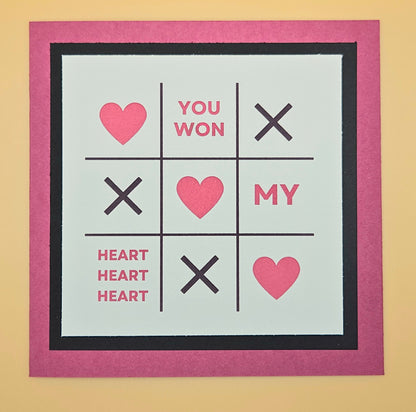 Noughts and Crosses game with hearts on a beige background