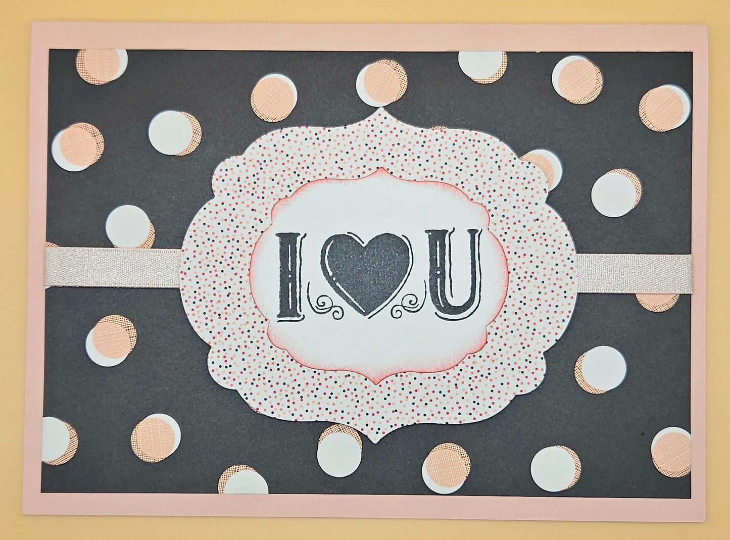 Card with 'I ❤️ U' text on a polka dot background
