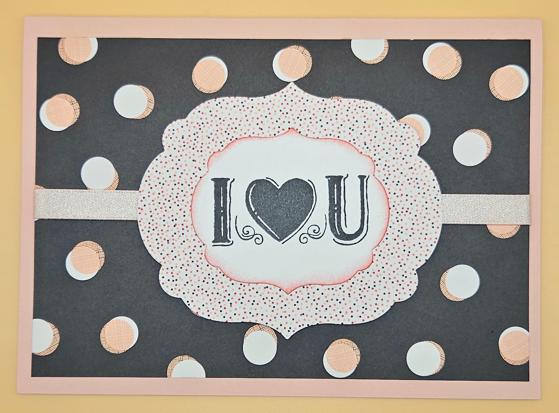 Card with 'I ❤️ U' text on a polka dot background