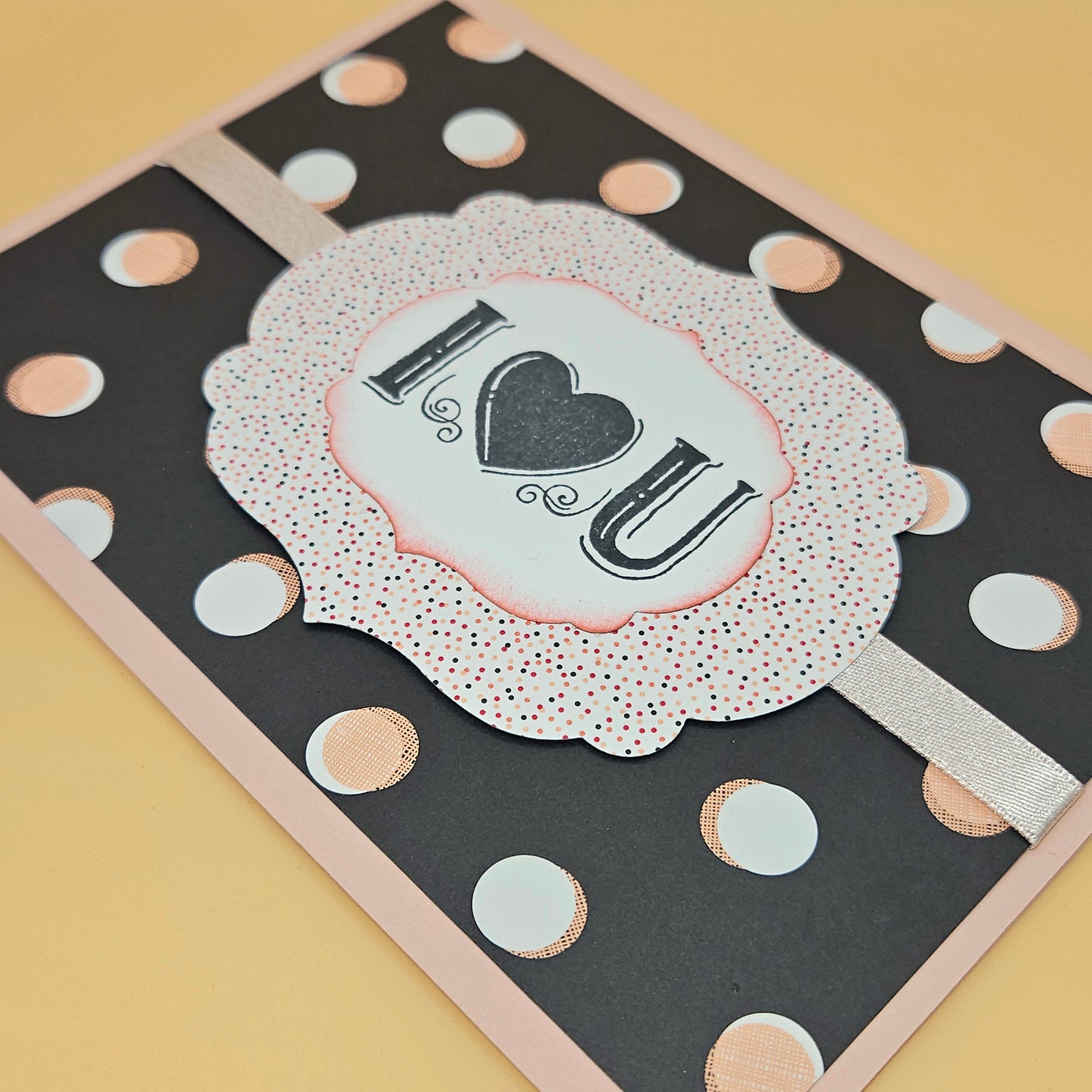 Greeting card with 'I ❤️ U' text on a polka dot background