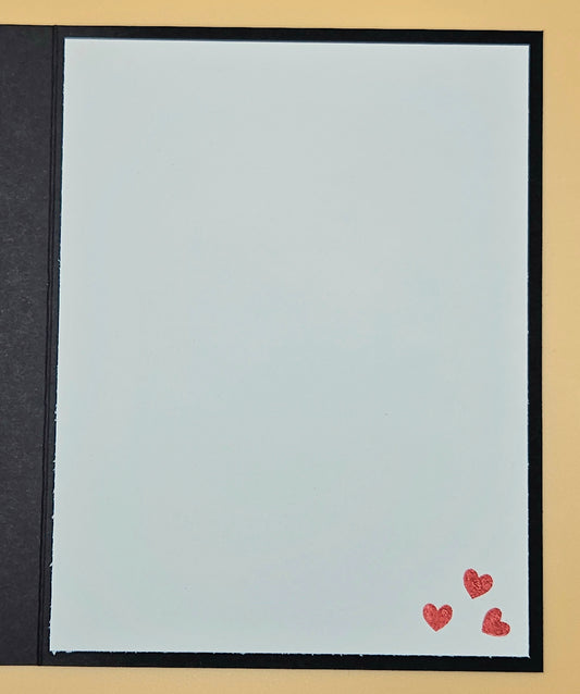 Plain light blue card with two red hearts on a beige background