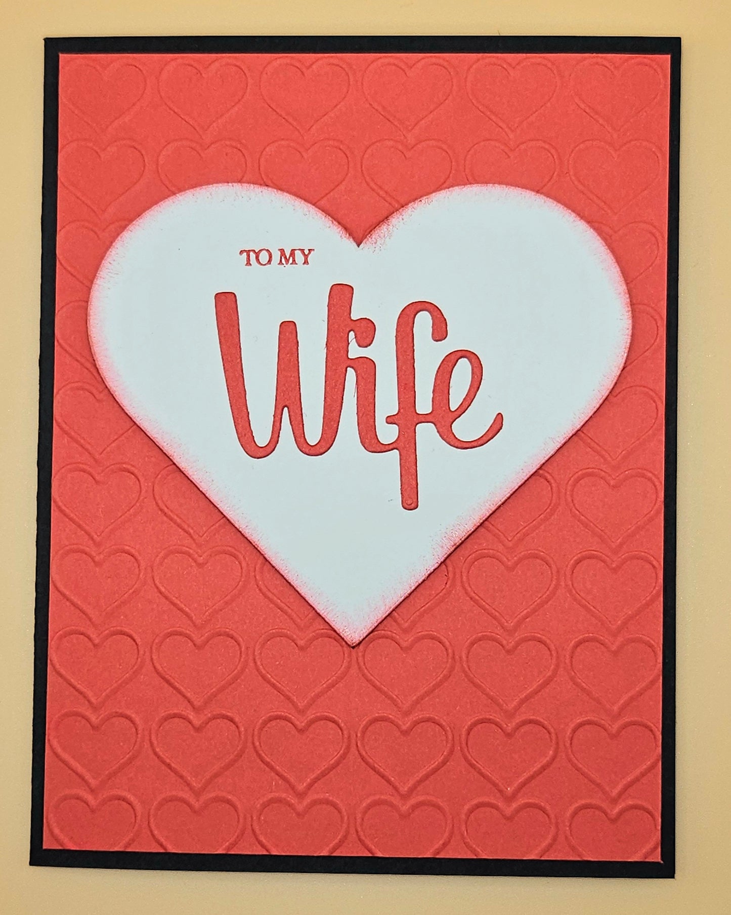 Card with a white heart on a red background, featuring the text 'To My Wife'.