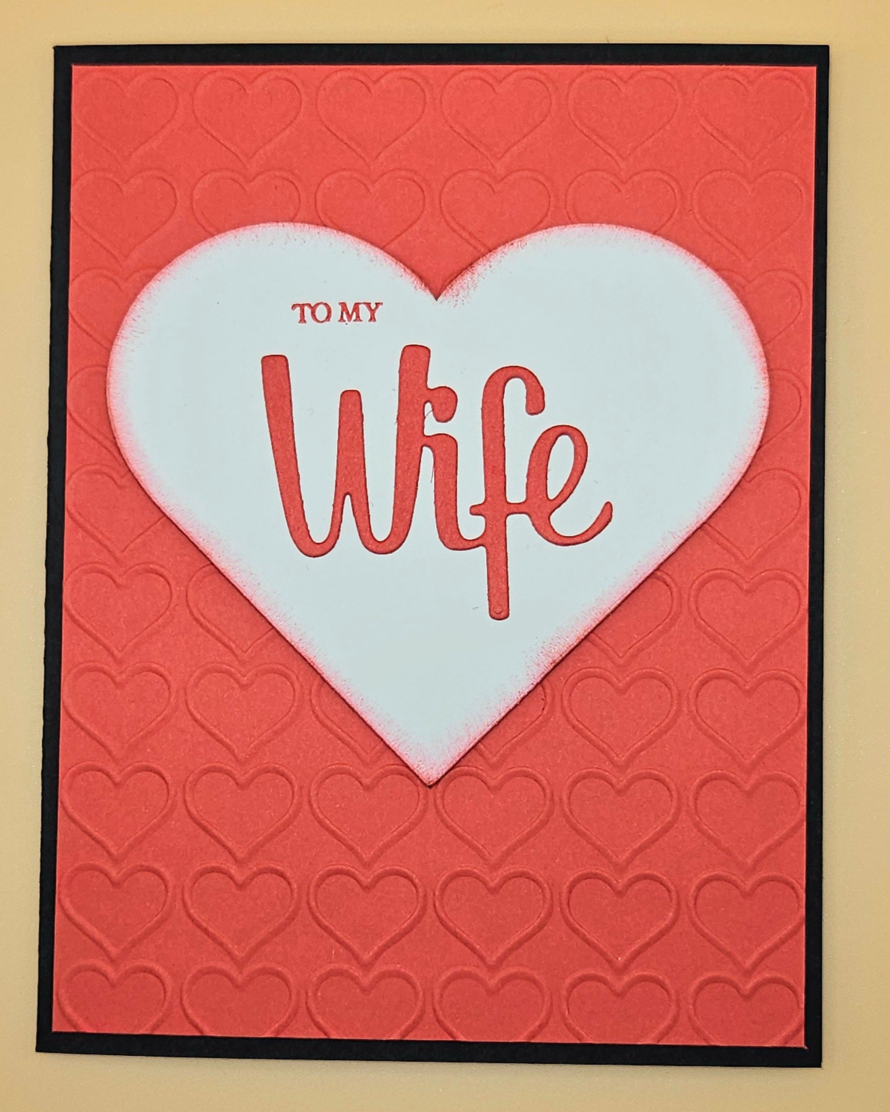 Card with a white heart on a red background, featuring the text 'To My Wife'.