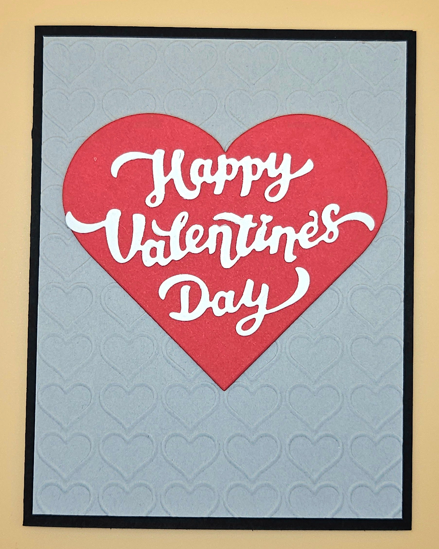 Valentine's Day card with red heart and 'Happy Valentine's Day' text on a gray background