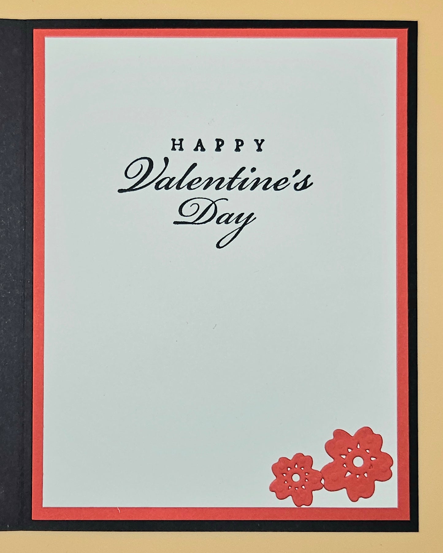 Valentine's Day card with 'Happy Valentine's Day' text and red flowers on a light blue background.