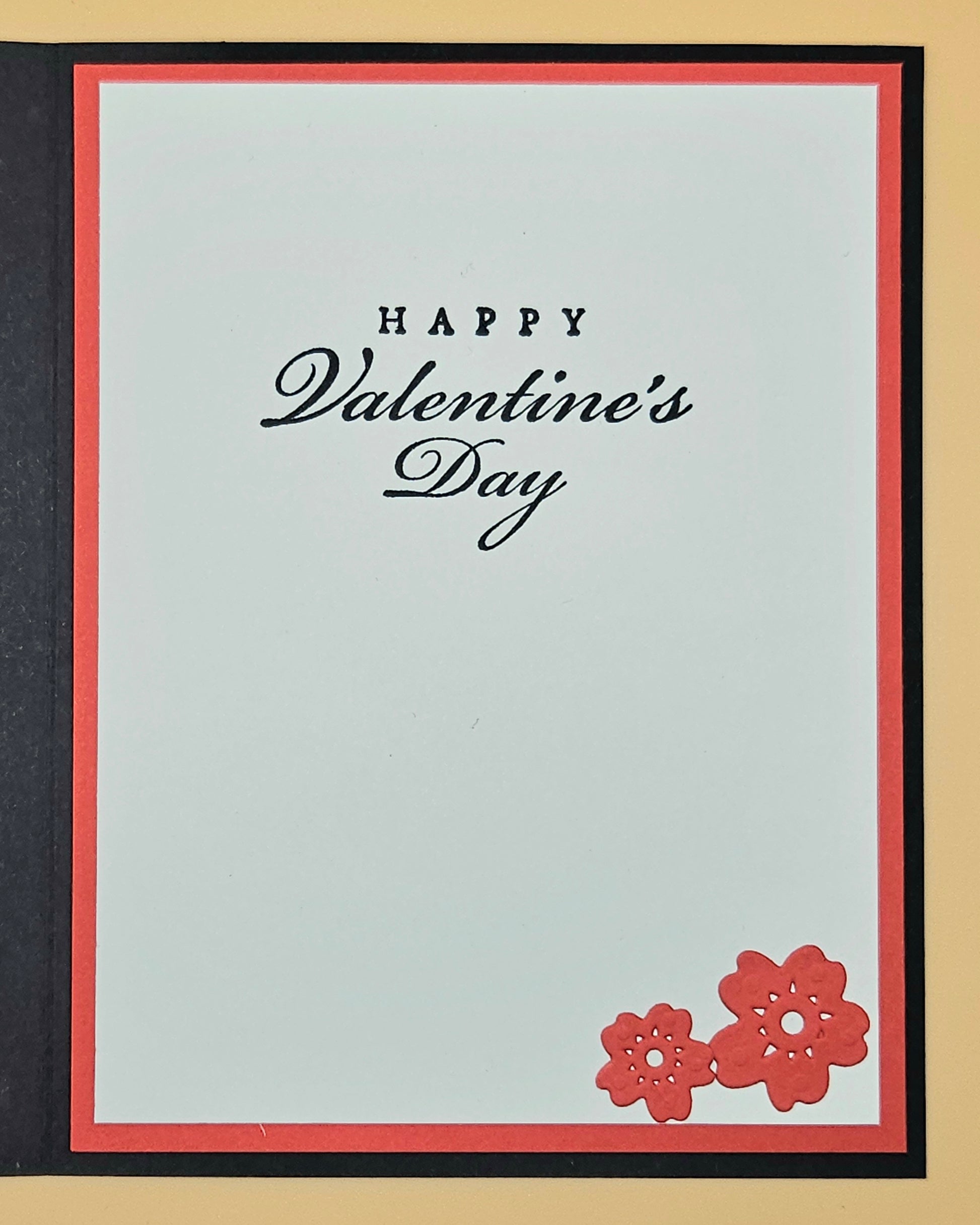 Valentine's Day card with 'Happy Valentine's Day' text and red flowers on a light blue background.