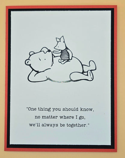 Cartoon illustration of a bear and a dog lying down with a quote on a light blue background.
