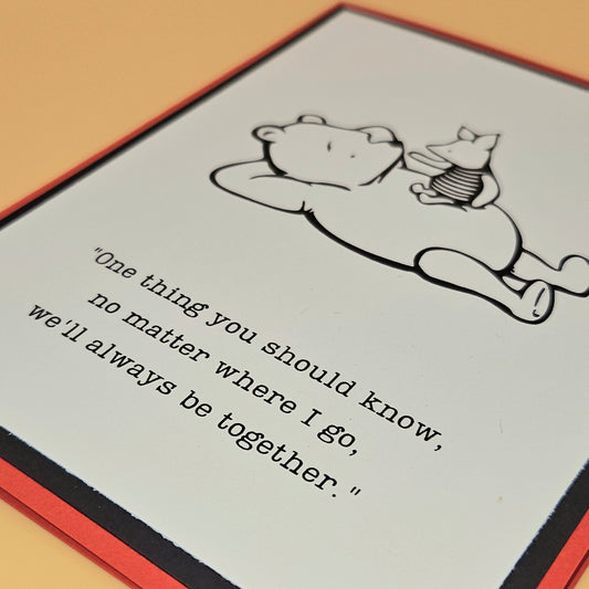 Illustration of a bear and a rabbit with a quote on a card.