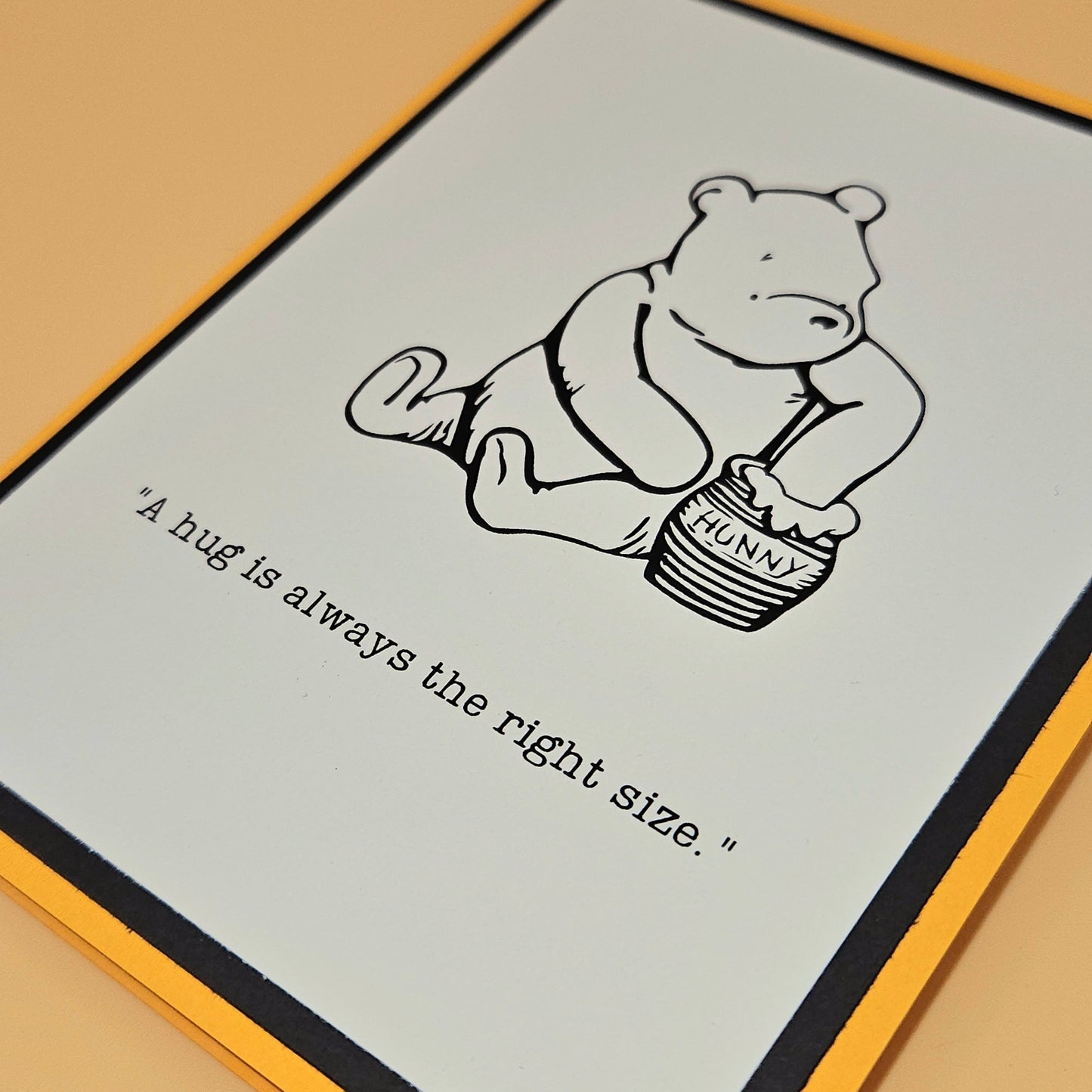 Cartoon bear holding a honey pot with text on a card