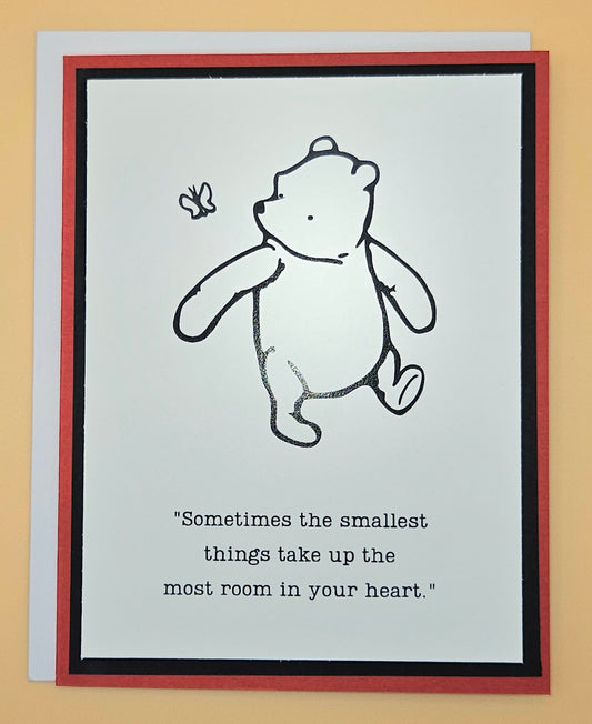 Card with a bear illustration and a quote on a beige background
