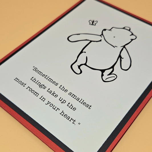 Card with a cartoon bear and a quote on a beige background