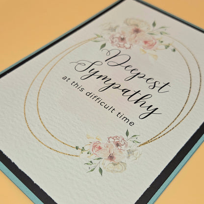 Sympathy card with floral design and text on a yellow background