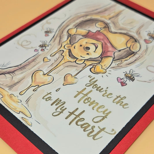 Card with Winnie the Pooh and text 'You're the Honey to my Heart' on a red border.
