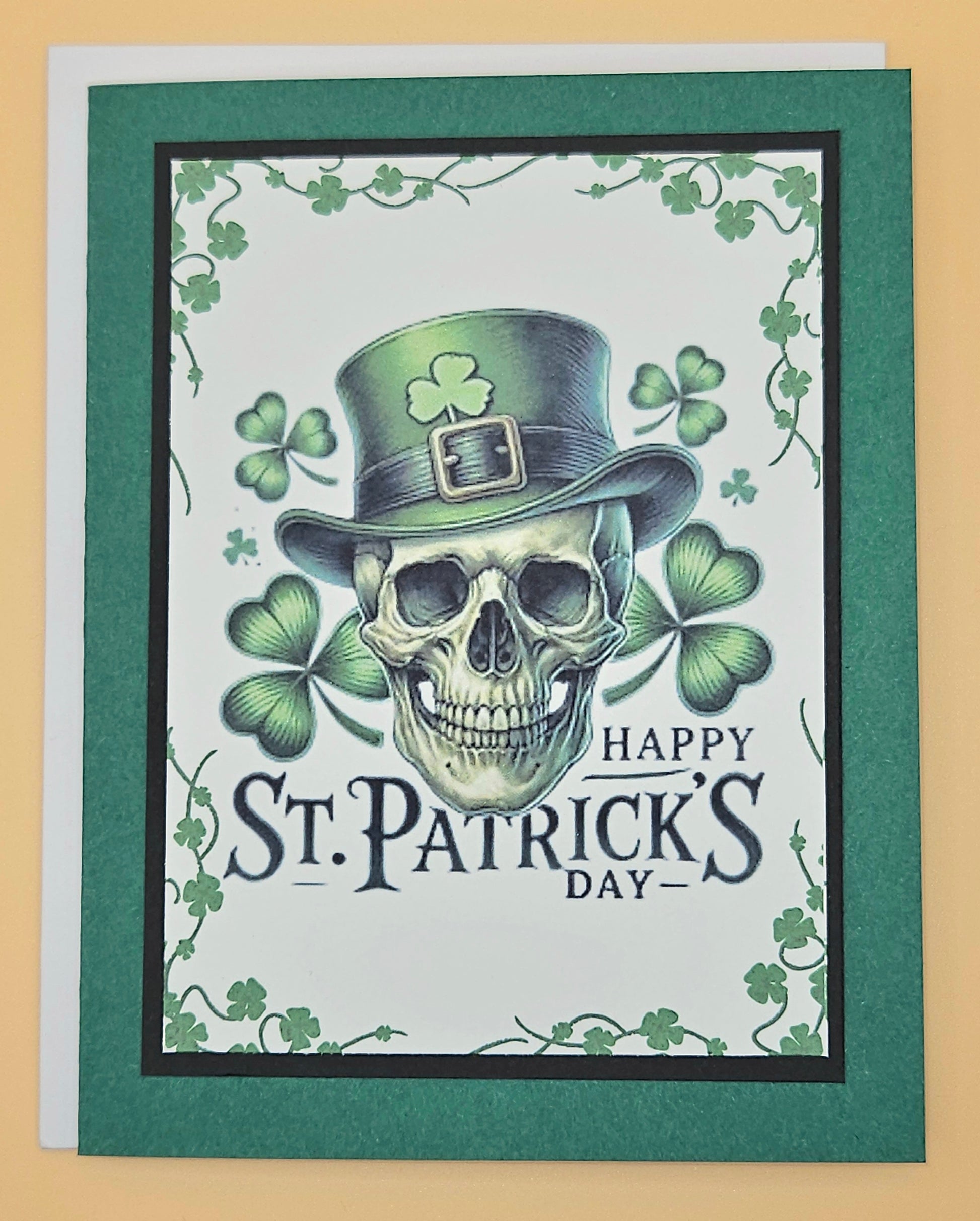 St. Patrick's Day card with a skull wearing a green top hat and shamrocks.