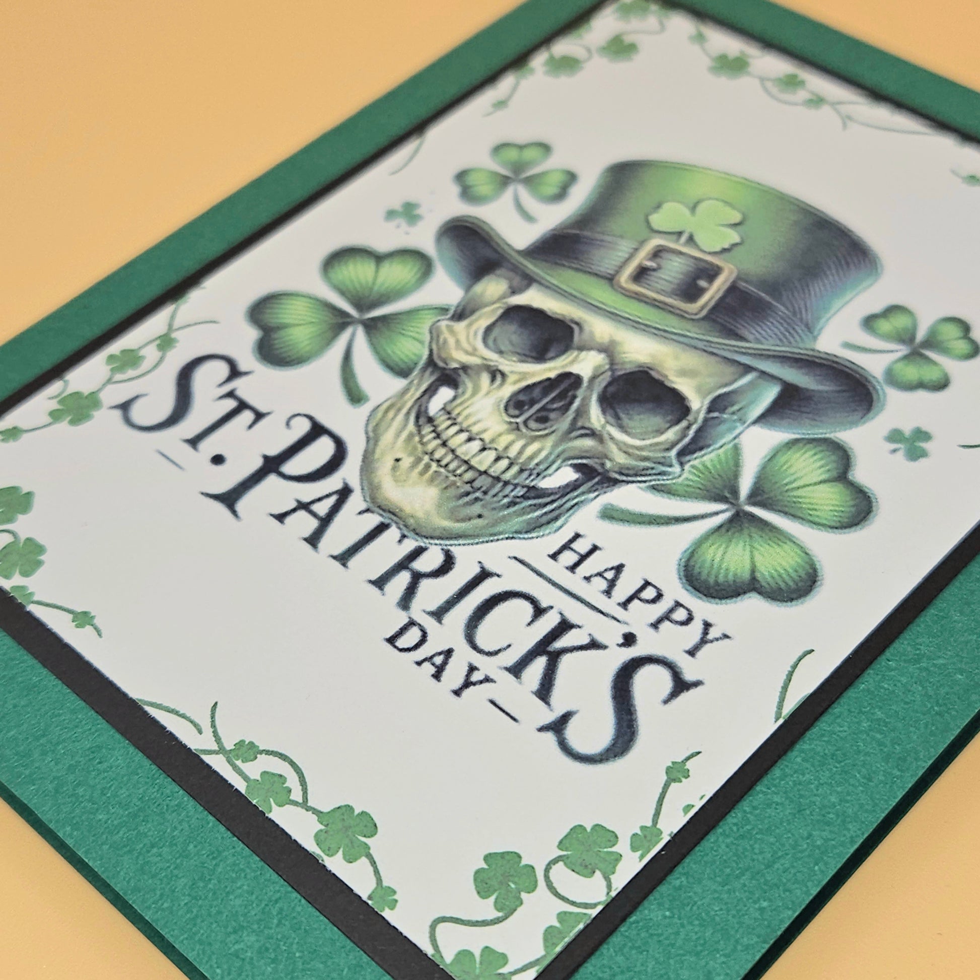 St. Patrick's Day card with a skull wearing a green hat and shamrocks.