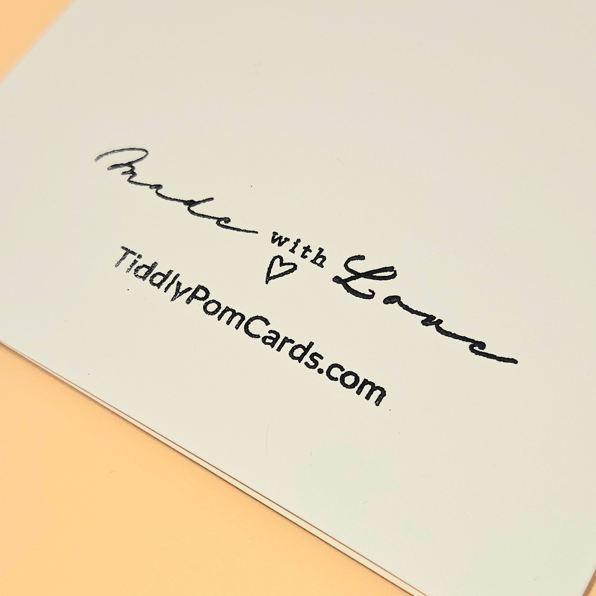 Card with 'Made with Love' text and a website URL on a beige background