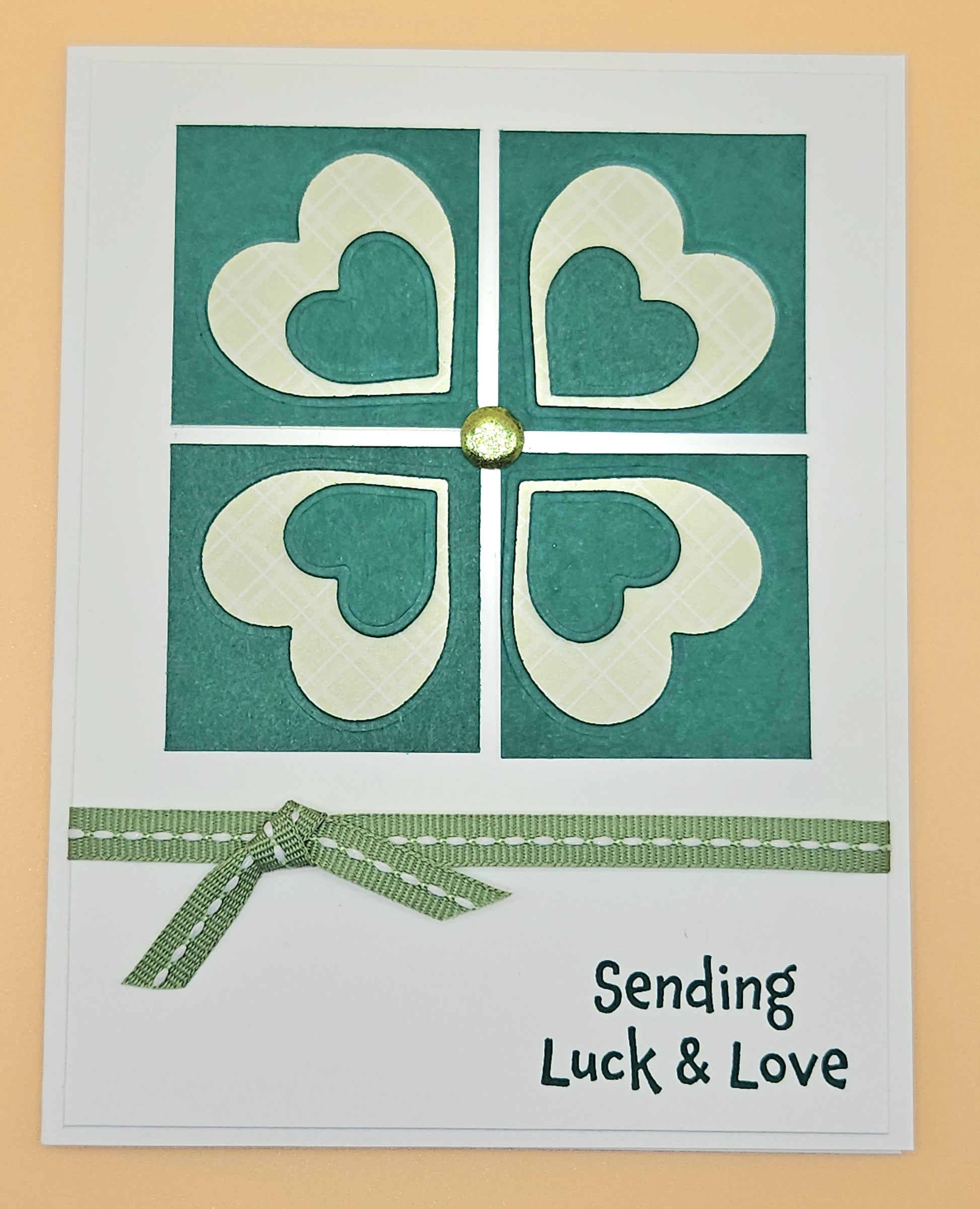 Card with heart design and text 'Sending Luck & Love' on a beige background