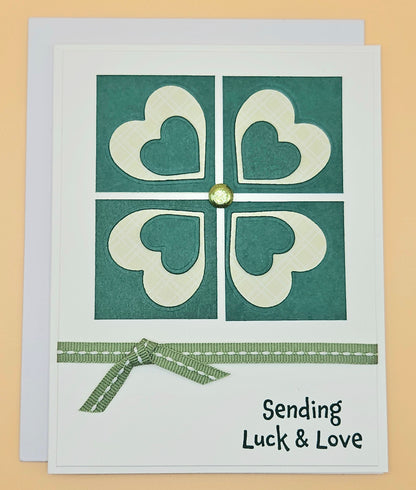 Card with heart design and text 'Sending Luck & Love' on a beige background