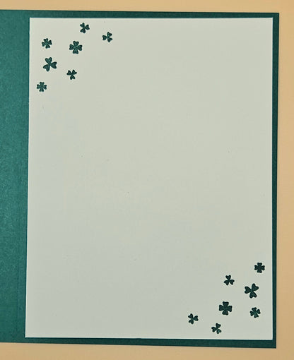 White paper with black four-leaf clover designs on a beige background