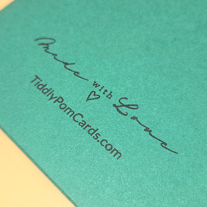 Green card with 'Made with Love' and TiddlyPomCards.com text on a wooden surface