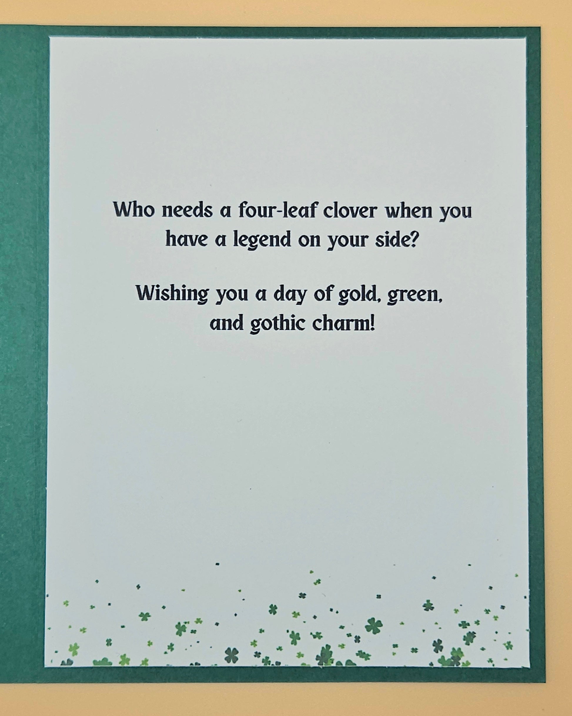 Card with a four-leaf clover design and humorous text on a light gray background.