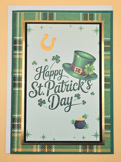 St. Patrick's Day card with green hat, pot of gold, and shamrock on a plaid border.
