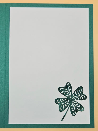 Four-leaf clover design on a white card with green border