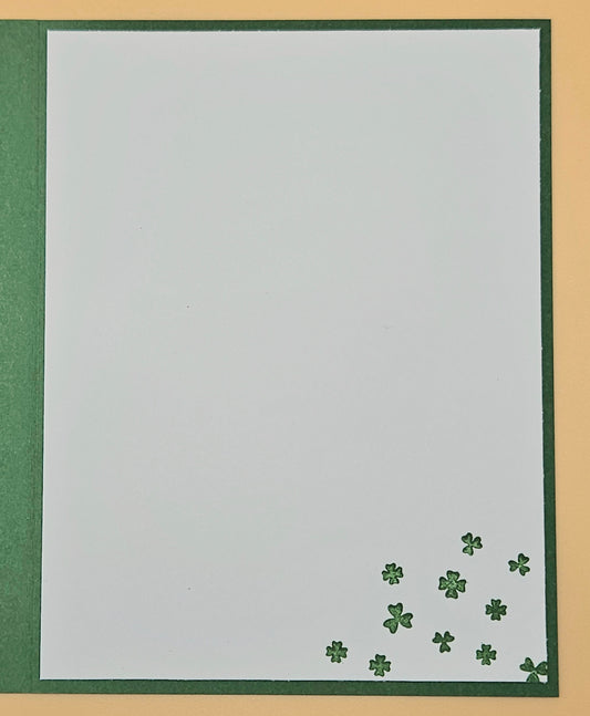 White card with green shamrock patterns on a gold and green border