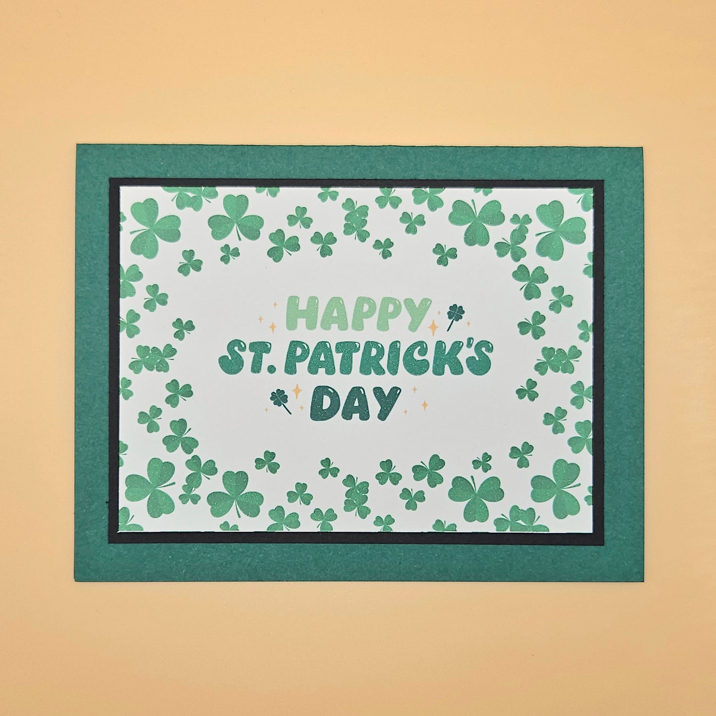 St. Patrick's Day card with shamrock pattern and 'Happy St. Patrick's Day' text on a beige background.
