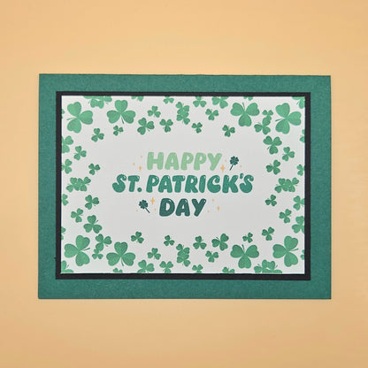 St. Patrick's Day card with shamrock pattern and 'Happy St. Patrick's Day' text on a beige background.
